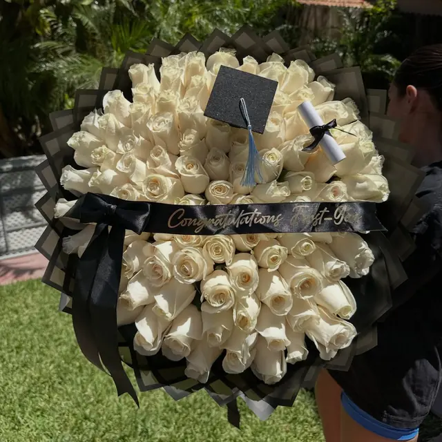 Cream and gold graduation bouquet with a mini cap