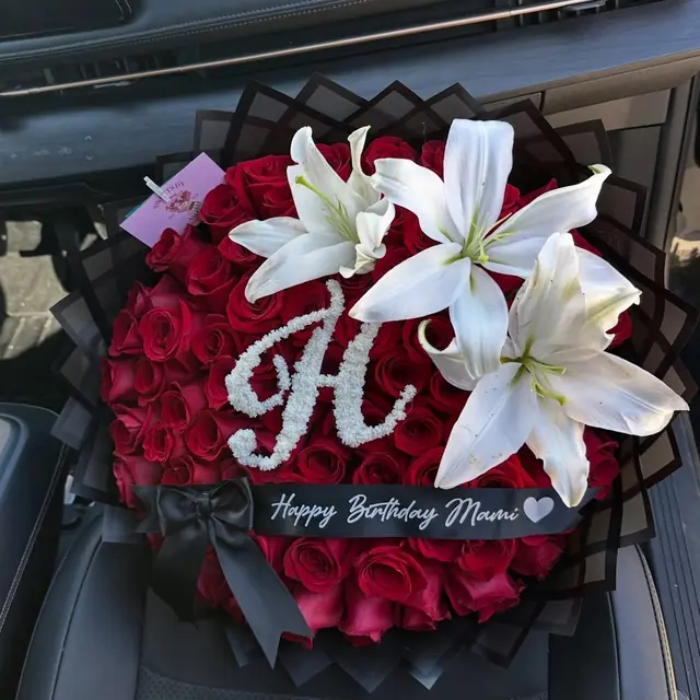 Red roses with white lilies and a baby's breath letter